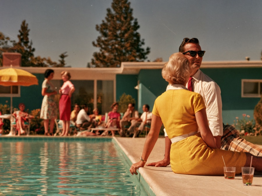 Families gathered poolside, talking and relaxing together